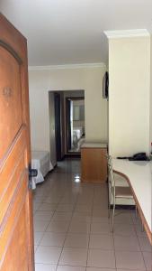 a room with a table and a chair in a room at Hotel Lago Alphaville in Apucarana