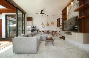 a living room with a couch and a table at Vila Padma Bali at Sayan - Ubud, A Trishula Collection in Ubud