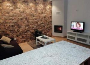 a living room with a couch and a tv at Casa Morgado in Braga