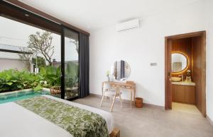 a bedroom with a bed and a swimming pool at Vila Padma Bali at Sayan - Ubud, A Trishula Collection in Ubud