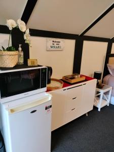 a living room with a microwave on a counter at Wharepai in Rotorua