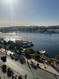 a view of a river with a boat in the water at Aisha guesthouse in Aswan +4 photos