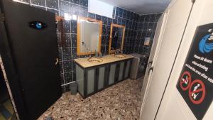 a bathroom with two sinks and a mirror at Habibi Hostel in Taghazout
