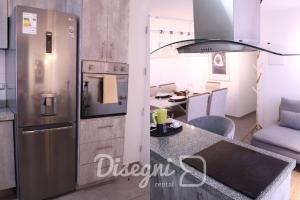 a kitchen with a stainless steel refrigerator and a table at Disegni 16 - Departamento Céntrico Copiapó 2 habitaciones, 6 personas in Copiapó