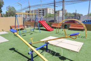 a playground with a slide and swings at Disegni 16 - Departamento Céntrico Copiapó 2 habitaciones, 6 personas in Copiapó