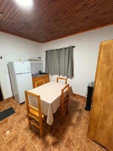 una cocina con una mesa y un refrigerador en Las Azaleas, en Puerto Iguazú