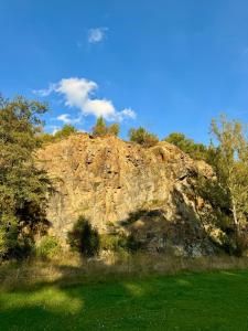 a large rock in the middle of a field at Ubytování uprostřed Evropy in Kouřim