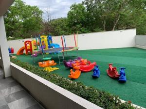 a playground with colorful play equipment on a balcony at Park Veredas Apto 705 in Rio Quente