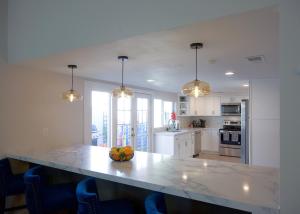 a kitchen with a table with a bowl of fruit on it at LUX NEW! Heated Pool Option, 2Kings, Spa, Old Town, WestWorld, Fashion Square in Scottsdale
