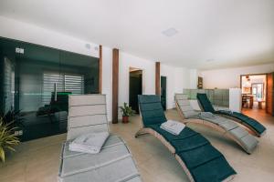 a living room with chairs and a room with at Čertova chalupa 