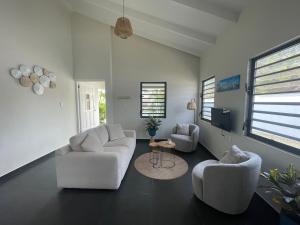 a living room with two couches and a tv at CasaPuru-at-JanThiel in Jan Thiel
