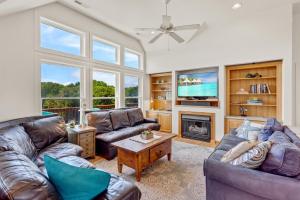a living room with two couches and a fireplace at 2070 - Sol Mates in Duck