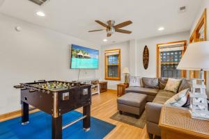 a living room with a foosball table and a couch at 2070 - Sol Mates in Duck