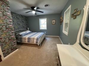 a bedroom with a bed and a ceiling fan at The Renovated Farmhouse at Seneca Rocks in Seneca Rocks
