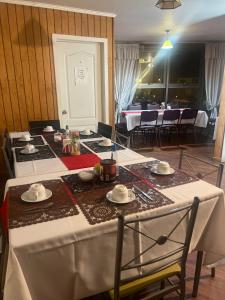 a table with a white table cloth on it at Hotel Plaza Los Leones in Curanilahue