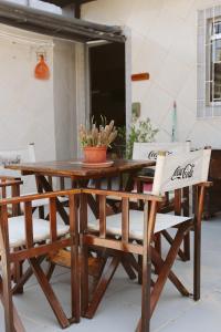 a wooden table and chairs with a potted plant on it at Pousada Mar Aberto Pinheira in Pinheira +131 photos