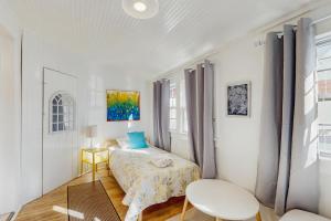 a white bedroom with a bed and a chair at Town of Rehoboth Beach --- 33 Maryland Ave in Rehoboth Beach