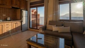 a living room with a couch and a glass table at Ain Chaouen in Chefchaouene