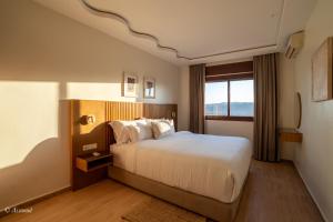 a hotel room with a bed and a window at Ain Chaouen in Chefchaouene