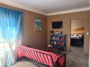 a living room with a bench and a window at Nawi Unit 2 in Potchefstroom