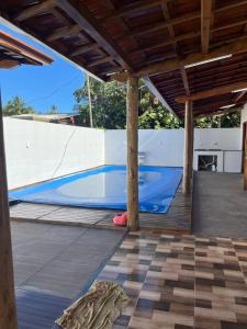 a swimming pool in the middle of a patio at Casa ponta da tulha in Ilhéus