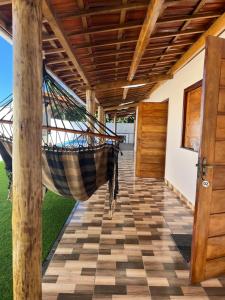a hammock hanging from the ceiling of a house at Casa ponta da tulha in Ilhéus