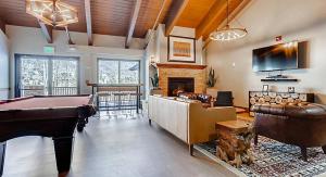 a living room with a pool table and a fireplace at Bluegreen Vacations Streamside at Vail, an Ascend Collection Resort in Vail