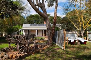 a white house with a tree and a fence at Moragoe Homestead in Werona