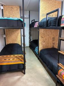 a room with two bunk beds in a dorm room at Colibrí - Smart Hostel in San Juan