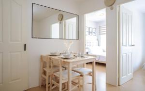 a dining room with a table and a mirror at SuiteEscape in Iloilo City