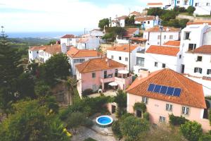 a group of houses with solar panels on their roofs at Charming Coastside Villa in Colares