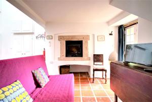 a living room with a pink couch and a fireplace at Charming Coastside Villa in Colares