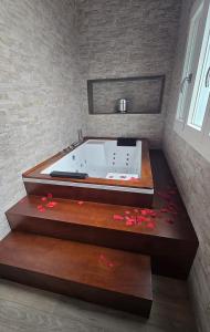 a bath tub in a bathroom with flowers on the floor at Samamà House in Taranto