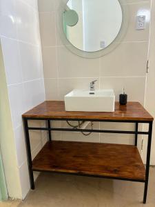 a bathroom with a sink and a mirror at Colibrí - Smart Hostel in San Juan +25 photos