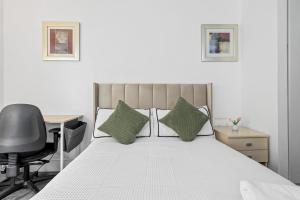 a bedroom with a bed with a desk and a chair at Ensuite Room in Canary Wharf with attached Bathroom in London