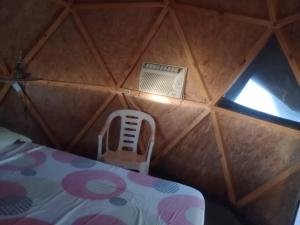 a room with a room with a bed and a window at EL ENCUENTRO Domo Geodesico in Miramar