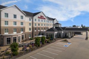an aerial view of a hotel with a parking lot at Hilton Garden Inn Cedar Falls Conference Center in Cedar Falls