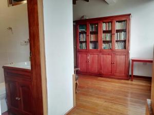 a bathroom with a red cabinet and a sink at Casa de Rosita in Quito