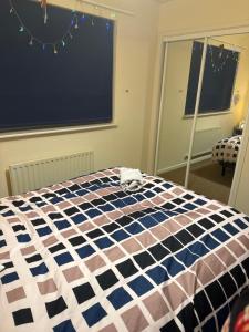 a stuffed animal laying on a bed in a room at Kilverston in Peterborough