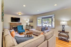 a living room with a couch and a fireplace at Spacious Fanwood Home with Decks, Walk to Park! in Plainfield