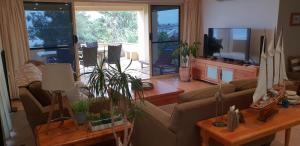 a living room with a couch and a table with plants at Southern Comfort in Point Turton