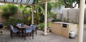 a patio with a table and chairs and a stove at Southern Comfort in Point Turton