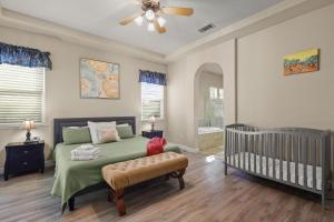 a bedroom with a bed and a crib in it at The Rivercrest Branch House - Close to Costco, Boat Ramp, Fishing, and Shopping in Redding