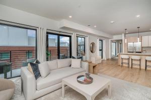 a living room with a couch and a table at Hyve - Tropical Penthouse - Pool & Gym in Nashville