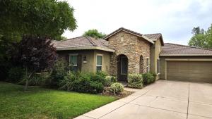 a brick house with a garage in a yard at The Rivercrest Branch House - Close to Costco, Boat Ramp, Fishing, and Shopping in Redding