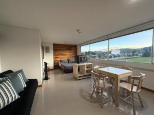 a living room with a table and a couch at Countryside apartment in Rionegro