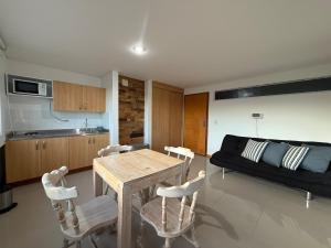 a living room with a table and chairs and a couch at Countryside apartment in Rionegro