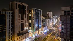 a view of a city at night with buildings at Hotel 21 Makkah in Makkah