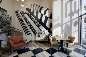 a lobby with a staircase and a table and chairs at Hotel 21 Makkah in Makkah +63 photos