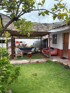 a house with a yard with a patio at hostel arcoiris urubamba in Urubamba